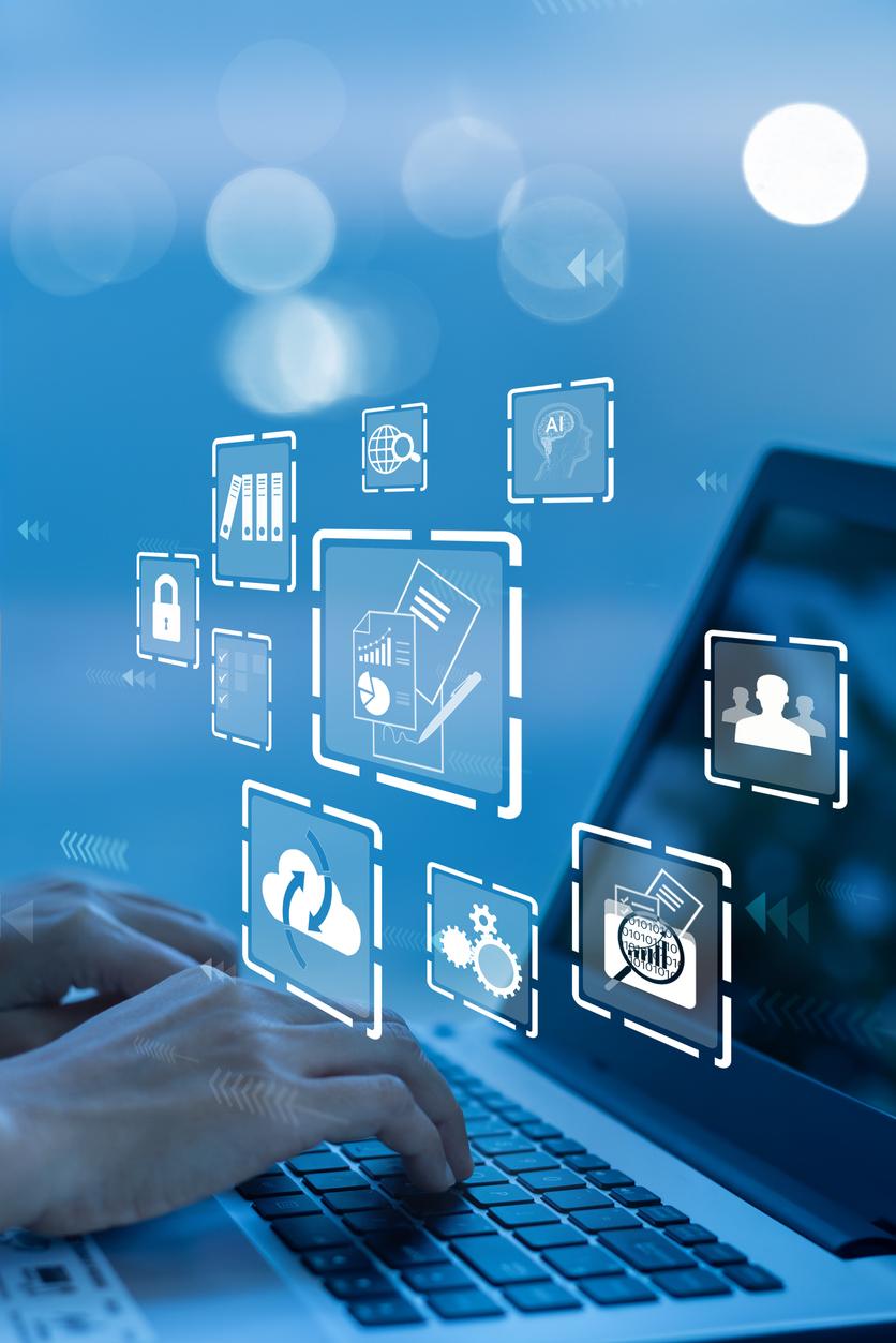 Hands on a laptop with floating app icons